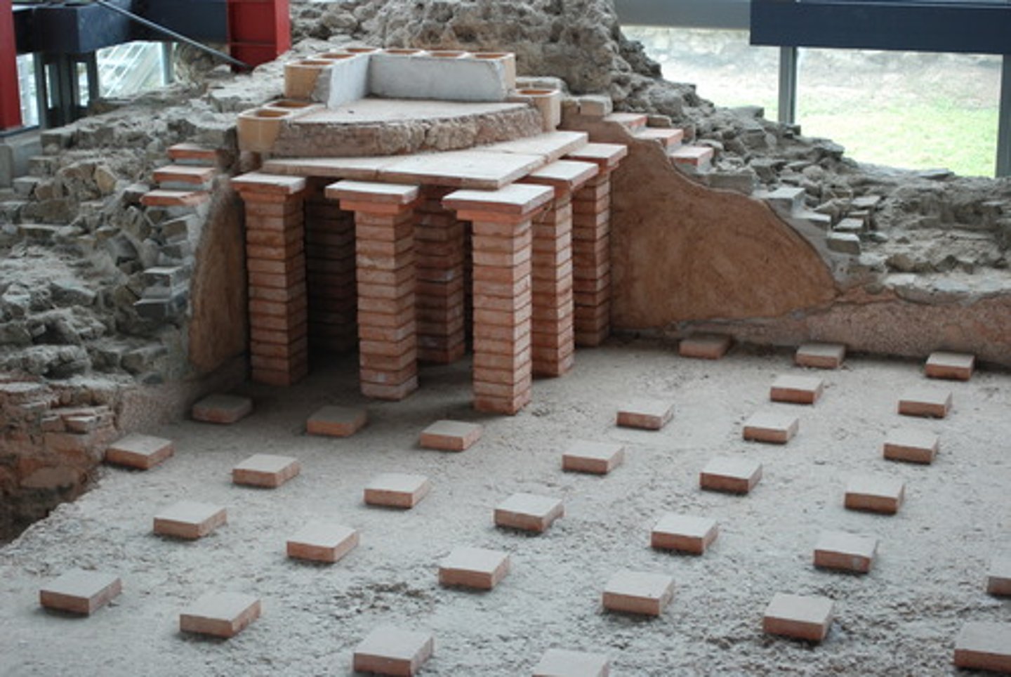 <p>- air heated by furnaces through empty spaces under the floors and out of pipes in the walls.</p><p>- first ever HVAC system</p><p>- invented by the Romans</p>