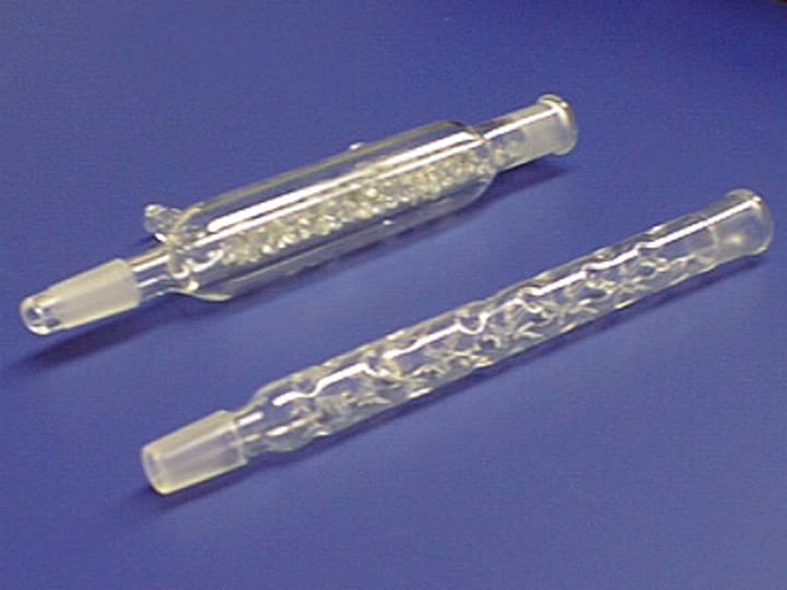 <p>a glass tube filled with beads</p>