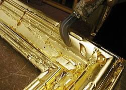 <p>covered thinly with gold or appearing as though covered in gold; wealthy or privileged.</p>