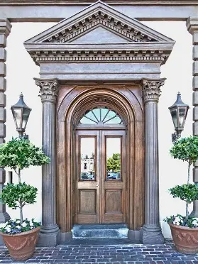 <p>a doorway that has some type of arch or gable above the doorway</p>