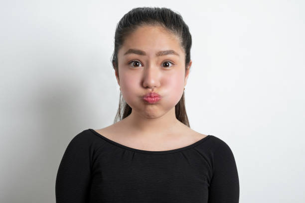 <ul><li><p>Muscle: <span style="color: rgb(177, 252, 252);"><strong><u>buccinator</u></strong></span></p></li></ul><ul><li><p><strong>Buccinator:</strong> This muscle forms the deep part of the cheek wall, running horizontally from the maxilla and mandible to the orbicularis oris muscle at the corner of the mouth.</p></li><li><p><strong>Action:</strong></p><ul><li><p><span style="color: rgb(177, 252, 252);"><strong>Chewing/Swallowing</strong></span><strong>:</strong> It compresses the cheek, pressing the food firmly against the teeth (mastication) and moving the food toward the pharynx (swallowing). It prevents food from collecting in the space between the cheek and teeth.</p></li><li><p><span style="color: rgb(177, 252, 252);"><strong>Whistling/Sucking</strong></span><strong>:</strong> It also flattens the cheek and is used to expel air, as in whistling, playing a wind instrument, or sucking.</p></li></ul></li></ul><p></p>