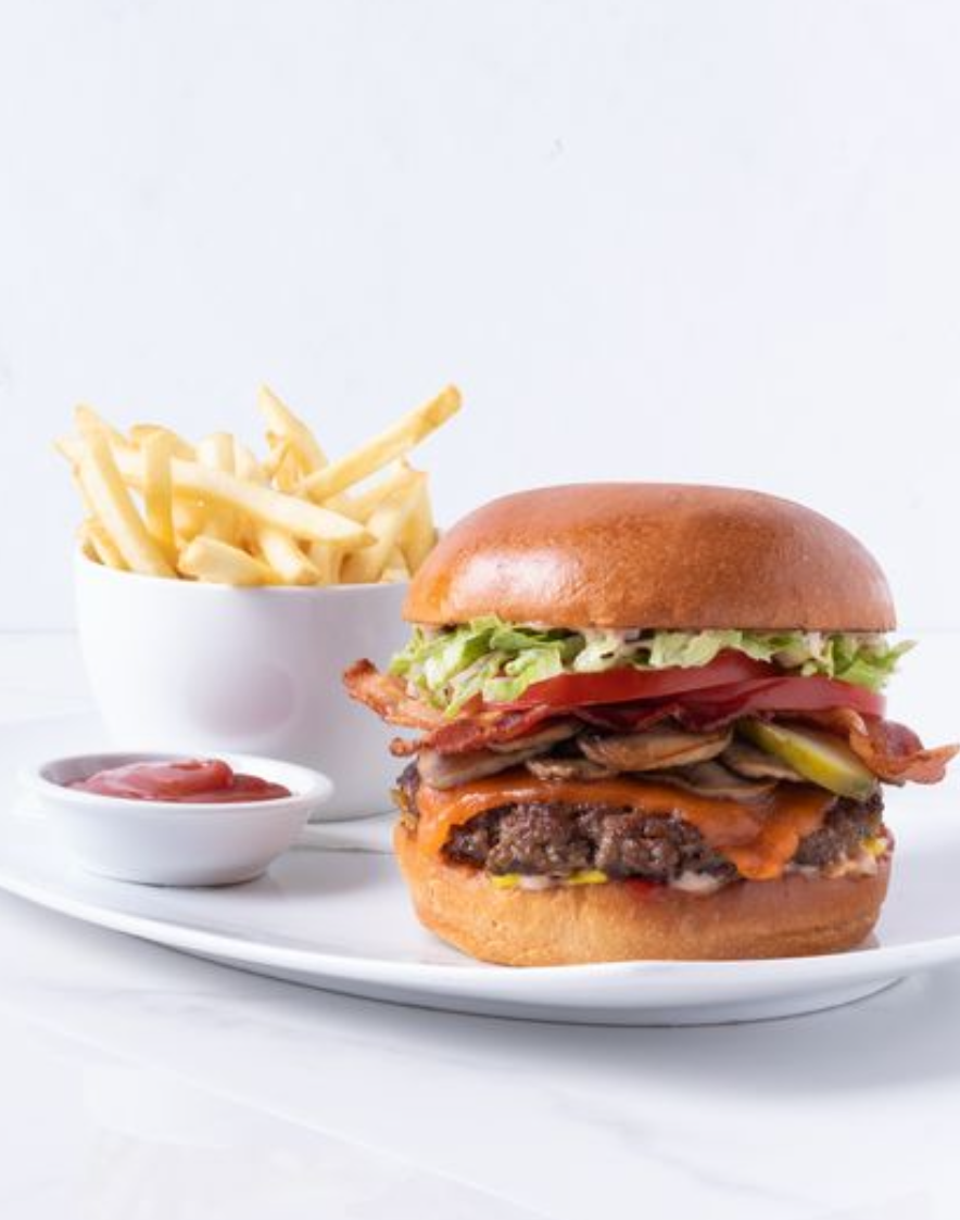 <p><span>Certified Angus Beef Patty, Cheddar cheese, Lettuce,  Smoked bacon, Relish-mayo, Mustard ➔ Brioche bun (or gluten free bun available),  Pickle,  Tomato,  Sauteed Mushrooms,  Ketchup, Sea Salted Fries</span></p>