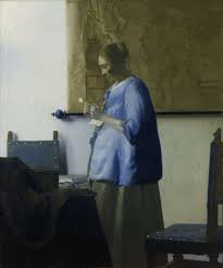 <p>Woman in blue reading a letter</p>