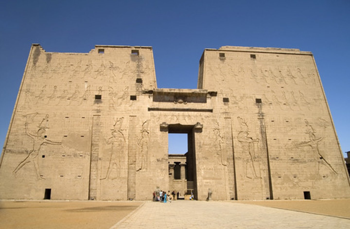 <p>Monumental gateway with sloping walls at an Egyptian temple entrance</p>