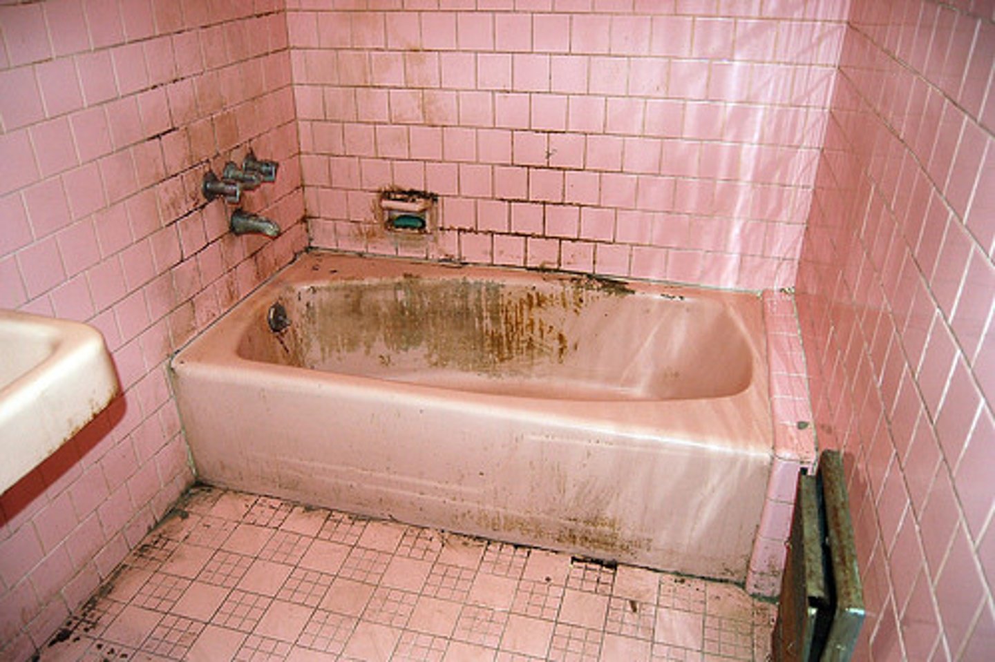<p>very dirty, covered with dirt or soot</p>
