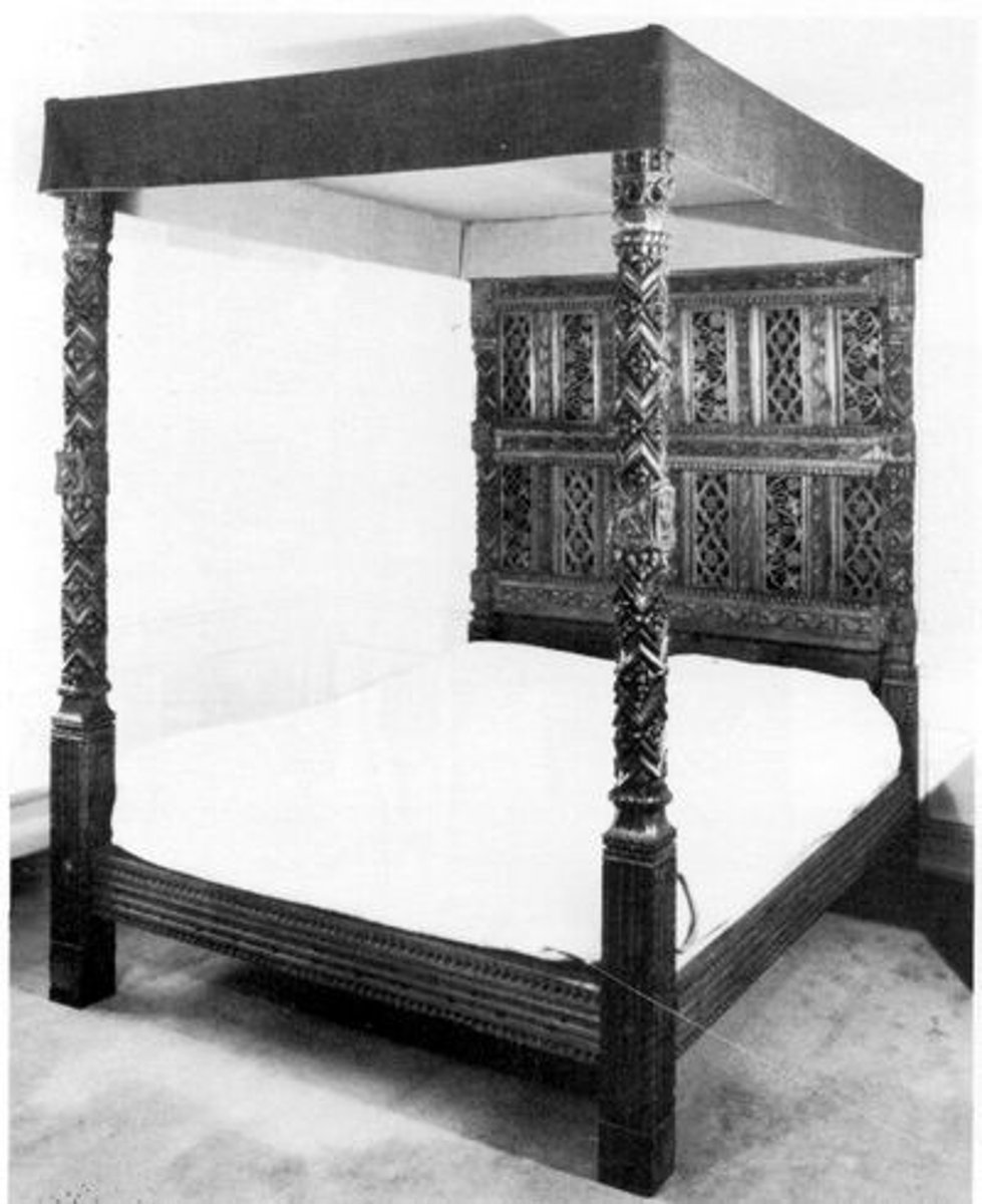 <p>What do you call a bed with a headboard featuring 12 carved panels and a grapevine scroll design?</p>