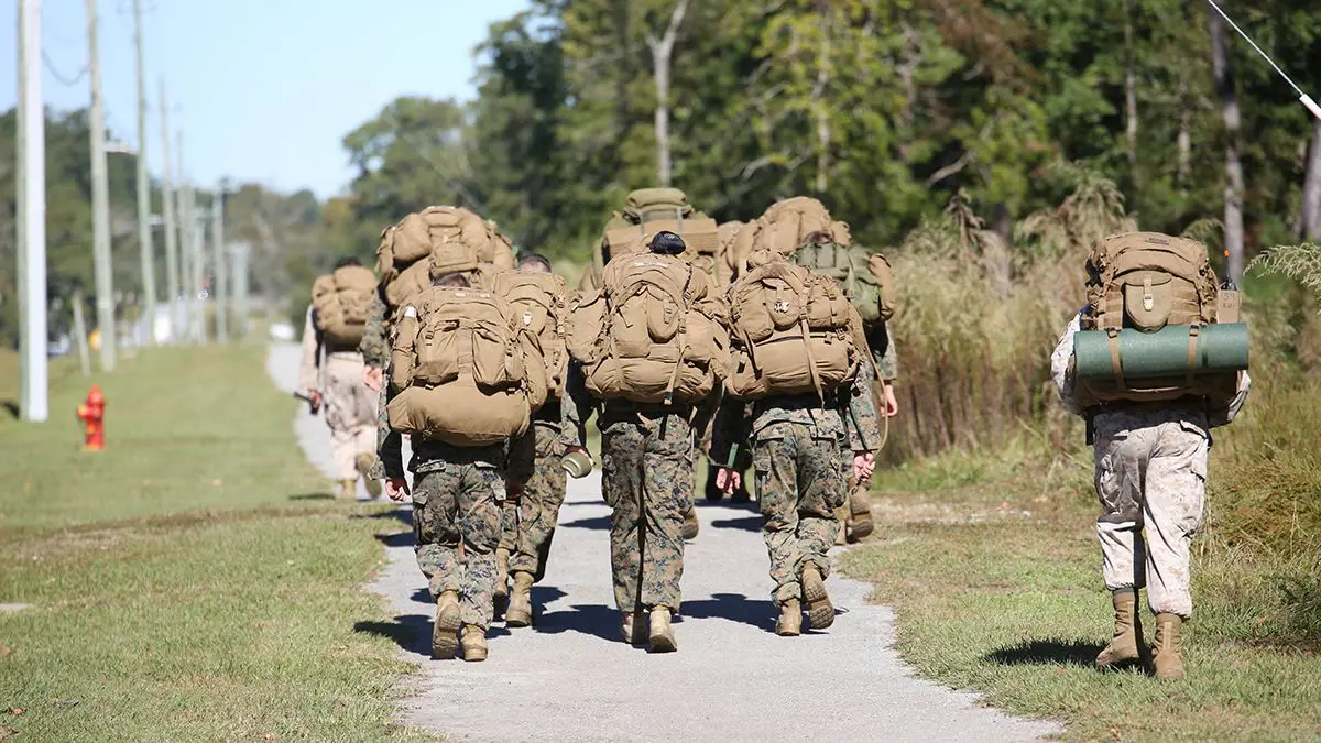 <p>Hump means to carry something heavy while marching</p>