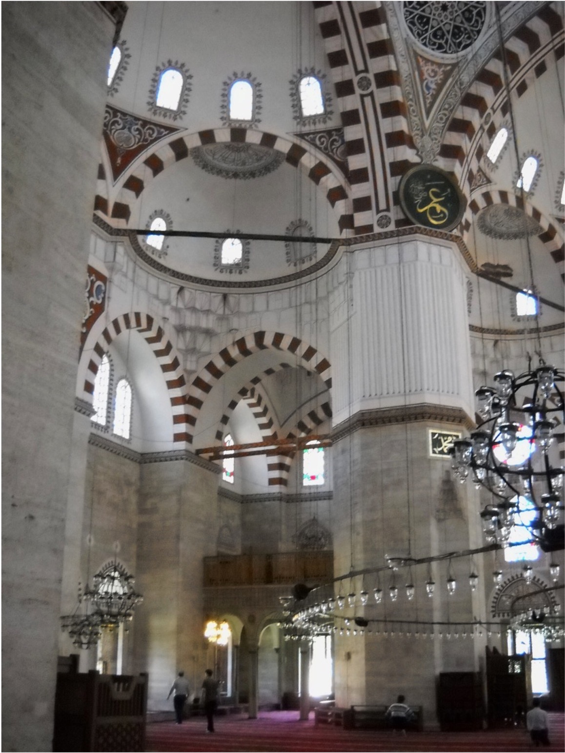 <ul><li><p>Complex was a true Ottoman külliye – containing mosque, madrasa, soup kitchen, bathhouse, dormitories, and the tombs of Mehmet and several other family members</p></li><li><p>Plan follows that of Hagia Sophia in many ways – but Sinan placed two more half domes around the main one, making a clover-leaf design</p></li><li><p>Plan abandons early Ottoman design w/ a fountain incorporated into mosque itself, in favor&nbsp;of the enclosed courtyard and fountain at Üç Şerefali Mosque</p><ul><li><p>However, Sinan’s architecture is perfectly balanced and coordinated</p></li></ul></li><li><p>Interior: the same canopy dome system (piers support all the weight)</p><ul><li><p>White walls and large piers that carry the weight of the dome – wanted lines of his architecture to stand out</p></li><li><p>Canopy piers → cut the corners off the square profile and carved a muqarnas arch into the resulting angle to lighten the effect, then added a ribbed section so upper part of the pier would match the white arches around it</p></li><li><p>Only area in the mosque showing any gold is the mihrab – continuing the Early Ottoman convention of concentrating all ornate decorative work around mihrab niche</p></li></ul></li><li><p>Dome had Ottoman stenciled designs</p><ul><li><p>Used mostly paint to decorate their mosques, rather than ceramics, mosaics, or marble inlays</p></li><li><p>Red and white arches are a direct reference to the bi-colored arches in the Dome of the Rock</p></li></ul></li><li><p class="MsoListParagraphCxSpMiddle">Since there are so many repeating forms, there is a kind of harmony in the architecture</p><ul><li><p class="MsoListParagraphCxSpMiddle">Design also allows for the insertion of many windows, which allow a great deal of light to enter the mosque</p><ul><li><p class="MsoListParagraphCxSpMiddle">This, plus white paint on the walls and white marble construction, allow for a very bright and airy interior</p></li></ul></li></ul></li><li><p class="MsoListParagraphCxSpMiddle">Exterior: also pure white marble, with only a touch of color in the terracotta inserts around the windows and the entrance arch</p></li><li><p class="MsoListParagraphCxSpMiddle">Sinan referred to the Şehzade Camii&nbsp;as the “Masterpiece of his Apprenticeship,” but was unhappy - four massive piers interrupted the open space of the prayer hall</p></li></ul><p></p>