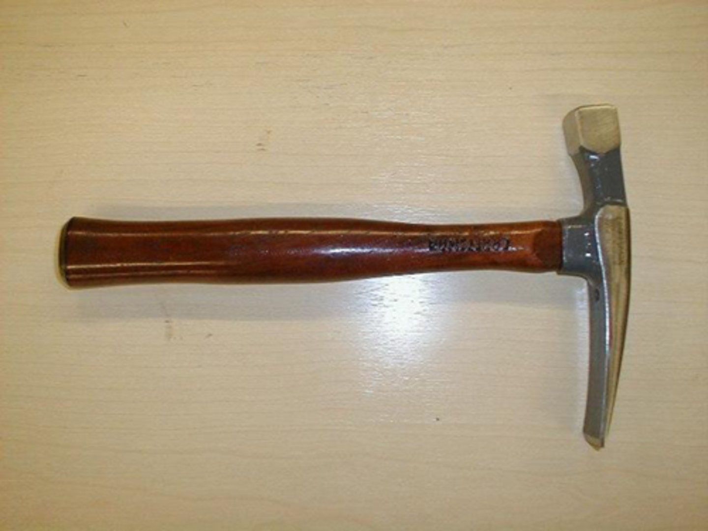 <p>chipping and shaping masonry material</p>