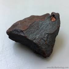 <p>black-reddish-brown color, metallic/dull luster, extremely hard</p>