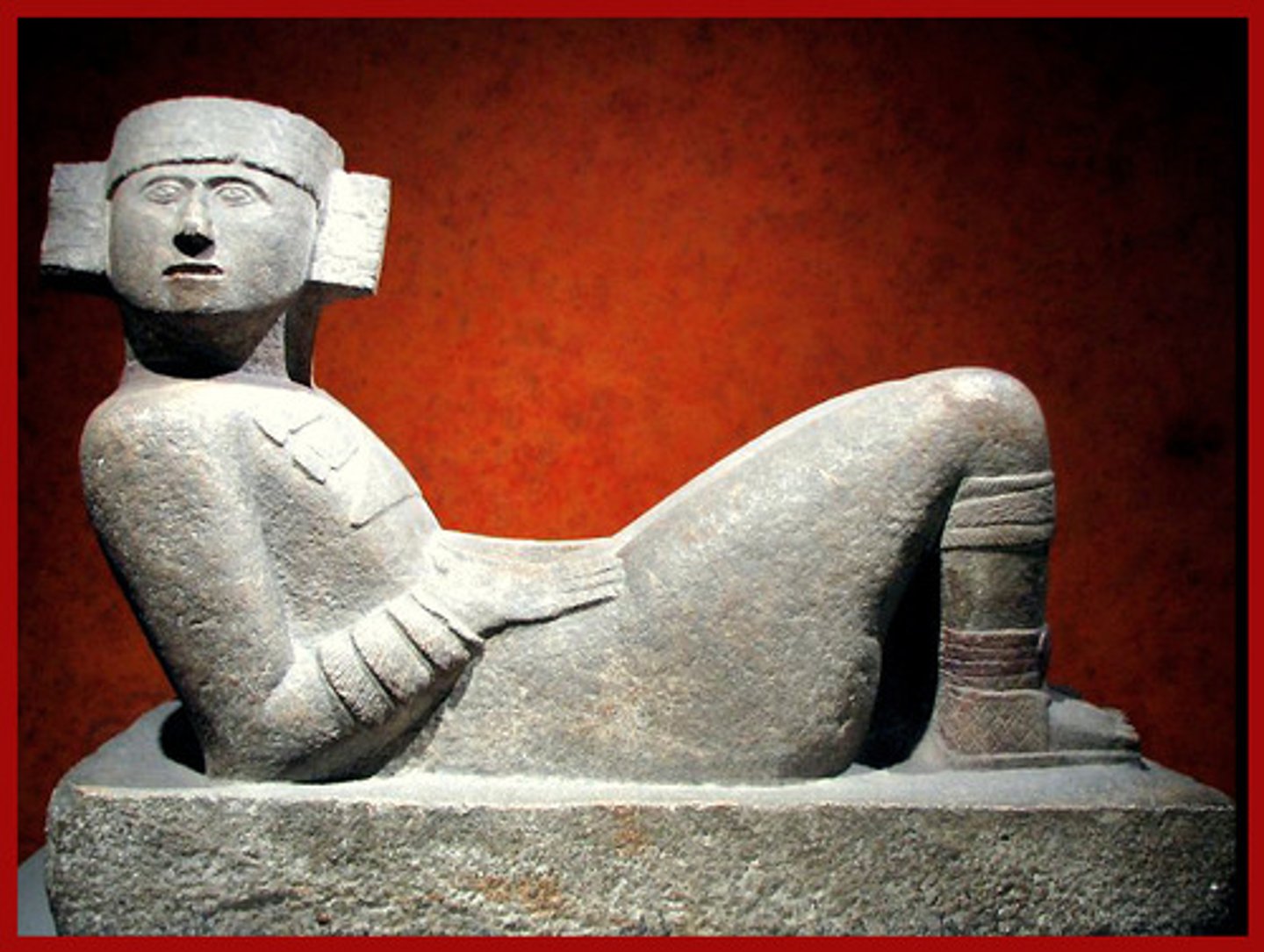 <p>a Mayan figure that is half-sitting and half-lying on his back</p>