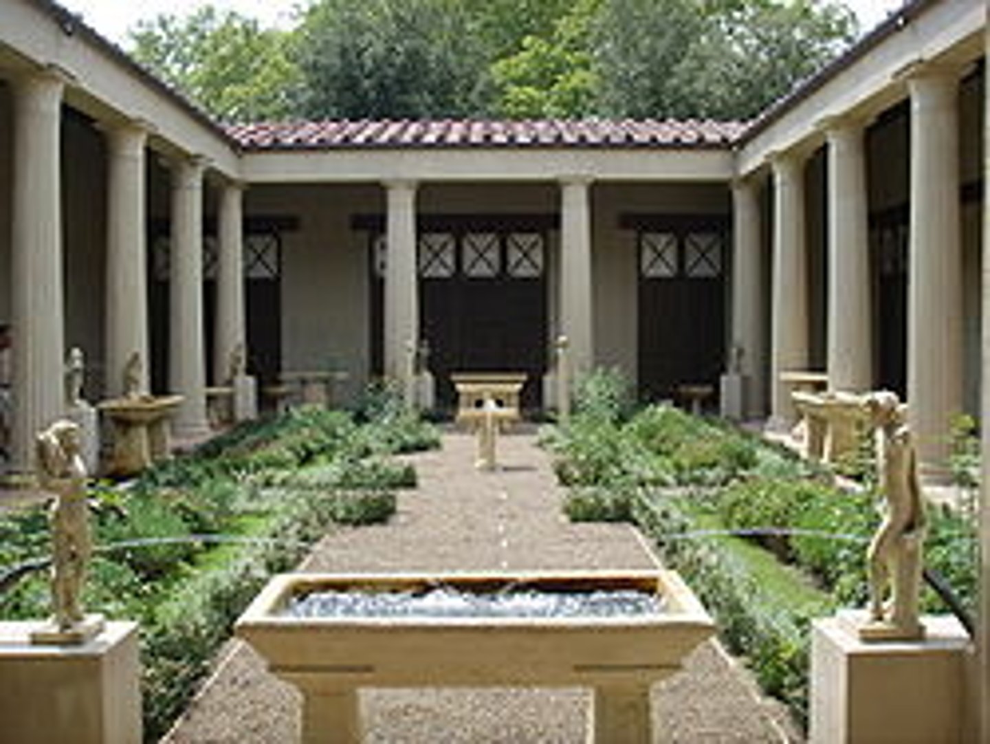 <p>a roofed, columned porch or colonnade surrounding a building or courtyard</p>