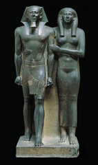 <p>-Graywacke, Approx. 4&apos; 6&quot; high, Old Kingdom, Gizeh, Egypt -King and Queen or King and Mother -Convention of painting men with red ochre and women with yellow ochre (remnants of the paint on them) -Didn&apos;t signify skin color, just gender -Arms interlocked symbolizing connection -Stepping forward with left foot, but hips stayed level unnaturally (not showing naturalism, showing timelessness/stillness that is suitable for a god)</p>