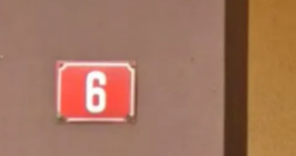 <p>Red house number with white text (may be czechia too)</p>