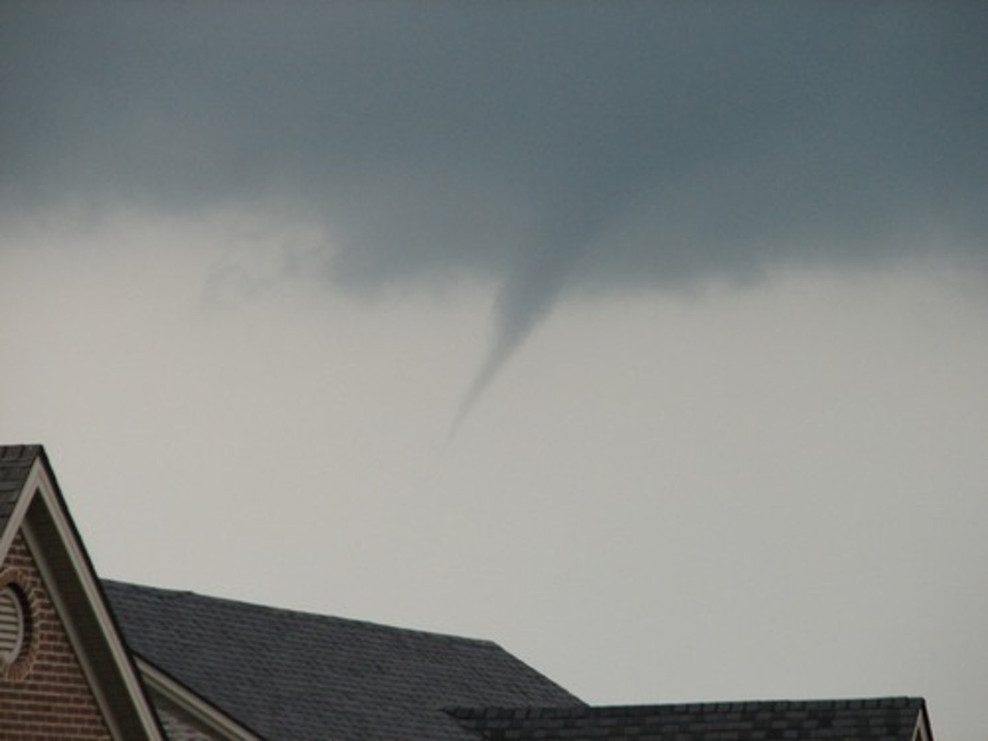 <p>a rotating funnel-shaped cloud forming the core of a tornado or waterspout.</p>