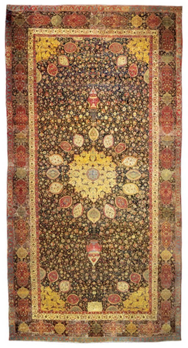 <p>-woven carpet made of silk</p><p>-Islamic Art tradition</p><p>-aray of colors and designs (lamp of the world)</p>