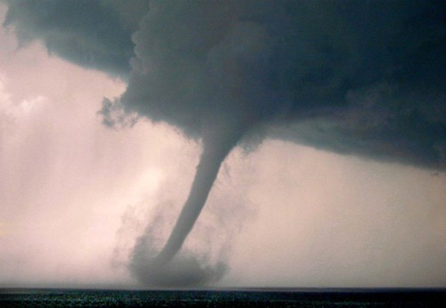 <p>A rapidly whirling, funnel-shaped cloud that reaches down to touch Earth's surface.</p>