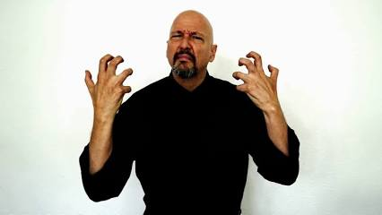 <p>“5” claw handshape in front of chest, move upward and outward + facial expression</p>