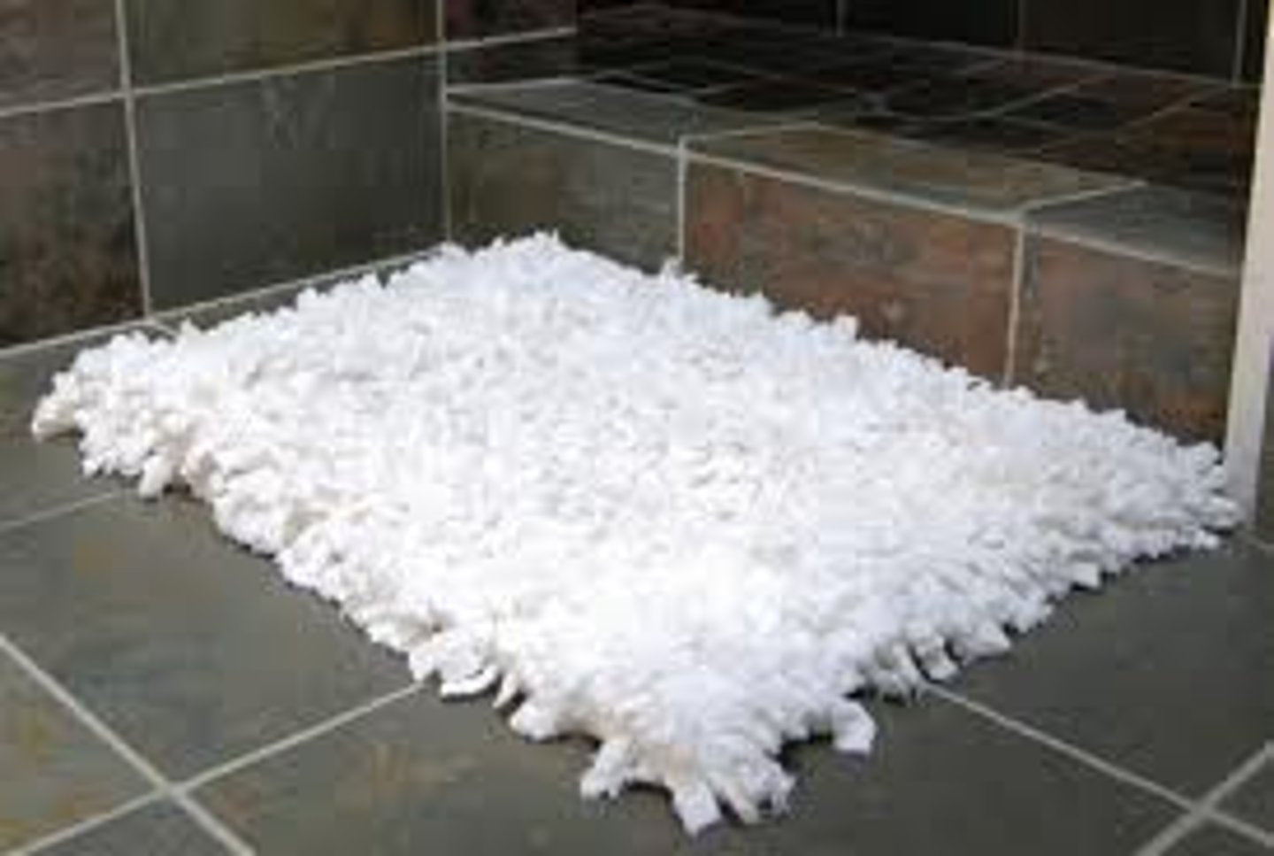 <p>a small piece of strong material that covers and protects part of a floor</p>