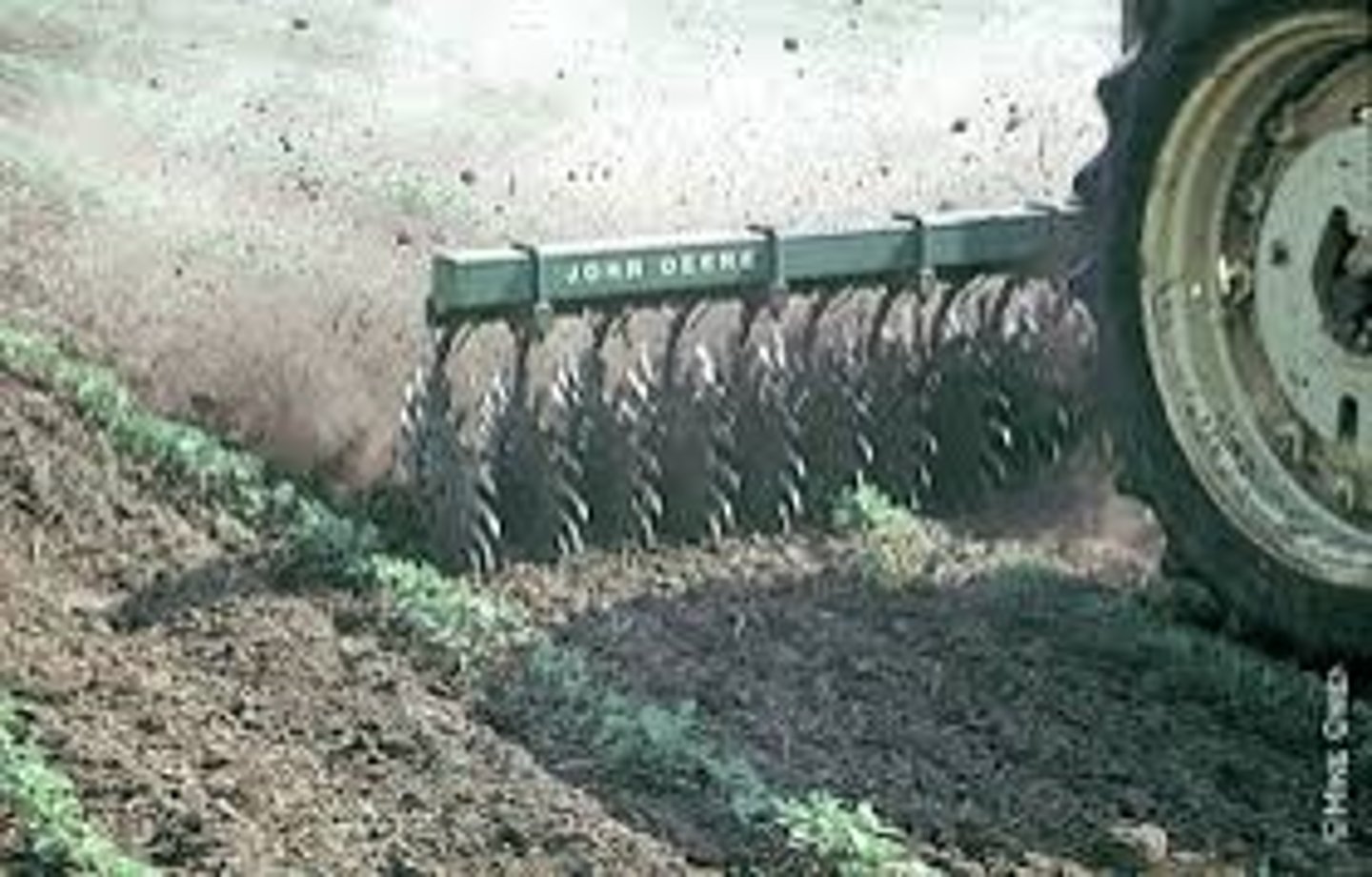 <p>an implement consisting essentially of a series of rotating hoe wheels each having many sharp curved steel prongs</p>