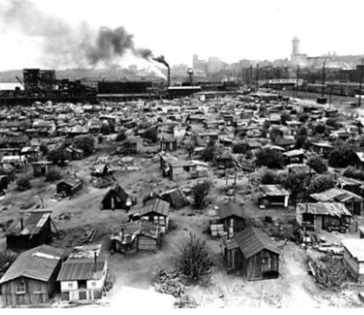 <p>(n) an area in or near a city in which poor people live in small, badly built houses</p>