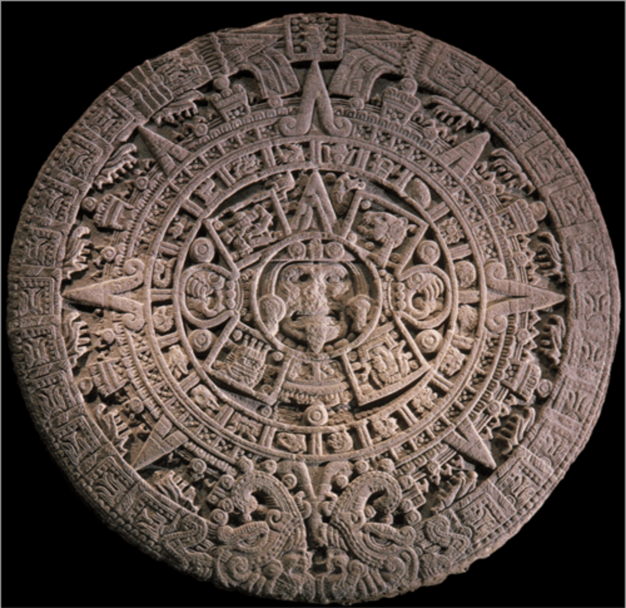 <p>Tenochtitlan (modern Mexico City, Mexico)</p><p>Mexica (Aztec)</p><p>1375-1520 CE</p><p>Form: Basalt</p><p>The calendar stone, or sunstone, is a relief cut, circular basalt stone that would have been brightly painted as well. The center of the stone is a face with a blade-like dagger for a tongue and claw hands. The Sun Stone was an altar-like structure for ritual ceremonies, such as sacrifices.</p>