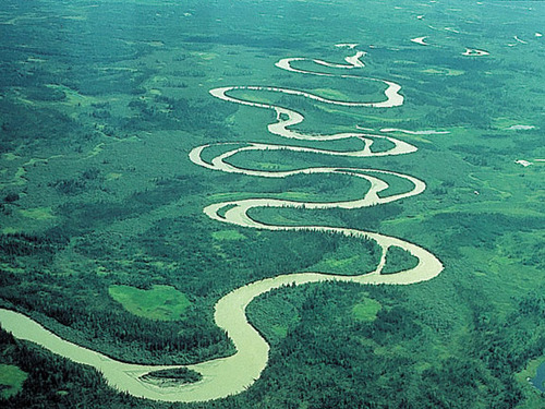 A river or small stream that curves back and forth across its valley