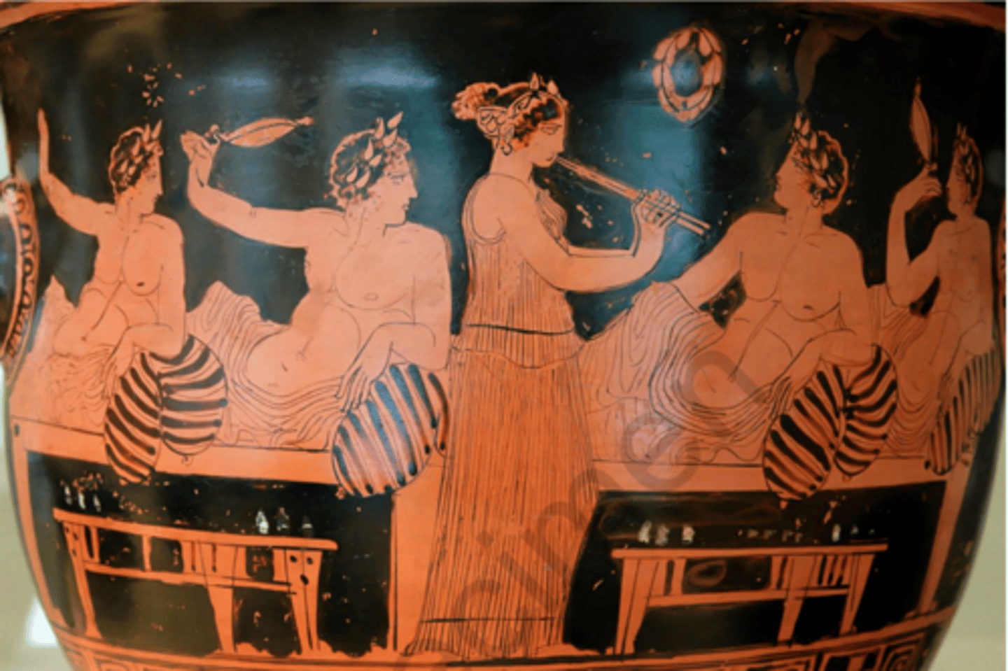 <p>All eyes on her, half-naked men recling around her, skin exposed, playing diaulos, playing drinking game, wreaths decorating room, nicely styled hair</p>