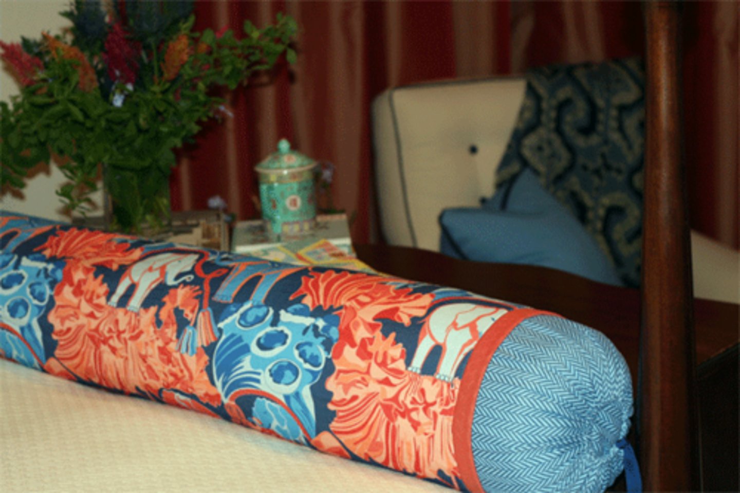 <p>Cylindrical shape pillows, often with decorative embellishments such as tassel, trims and gathers on either end</p>