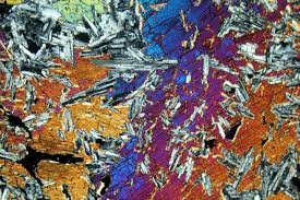 * contain smaller minerals enclosed in larger minerals; this texture documents 2 crystallization phases. The smaller minerals form in a first phase, leaving a relatively homogenous magma; larger minerals form during a second phase, which is characterized by slow cooling.