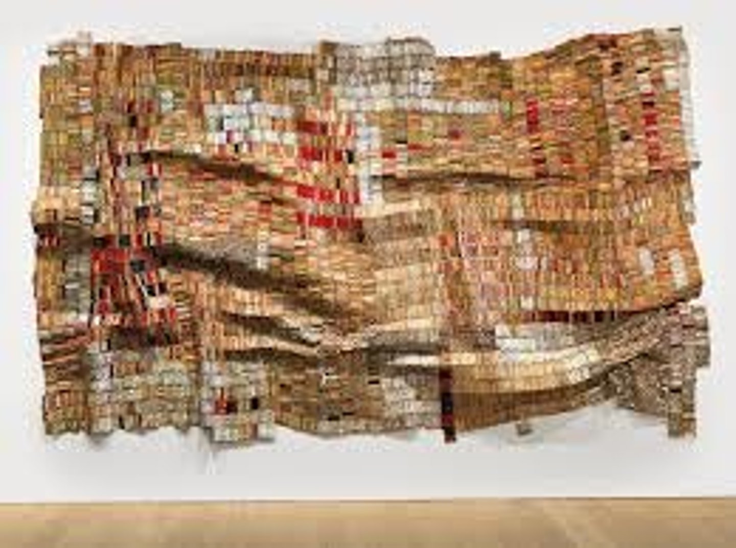 <p>El Anatsui</p><p>2003 CE</p><p>Form: Aluminum and copper wire</p><p>Function: Points out the effects of trade and colonization</p><p>In this piece he used recycled metal materials and connected them with copper wire, creating a cloth-like form, the metal used was from over 1,000 discarded liquor bottle tops. The symbolic meaning of the bottle tops refers to the fact that liquor was used by Europeans as an item of trade with Africans, eventually it became one of the commodities in the Transatlantic slave trade. The complicated introduction of alcohol, and later issues with addiction, make the medium of Anatsui's work also part of the meaning</p>