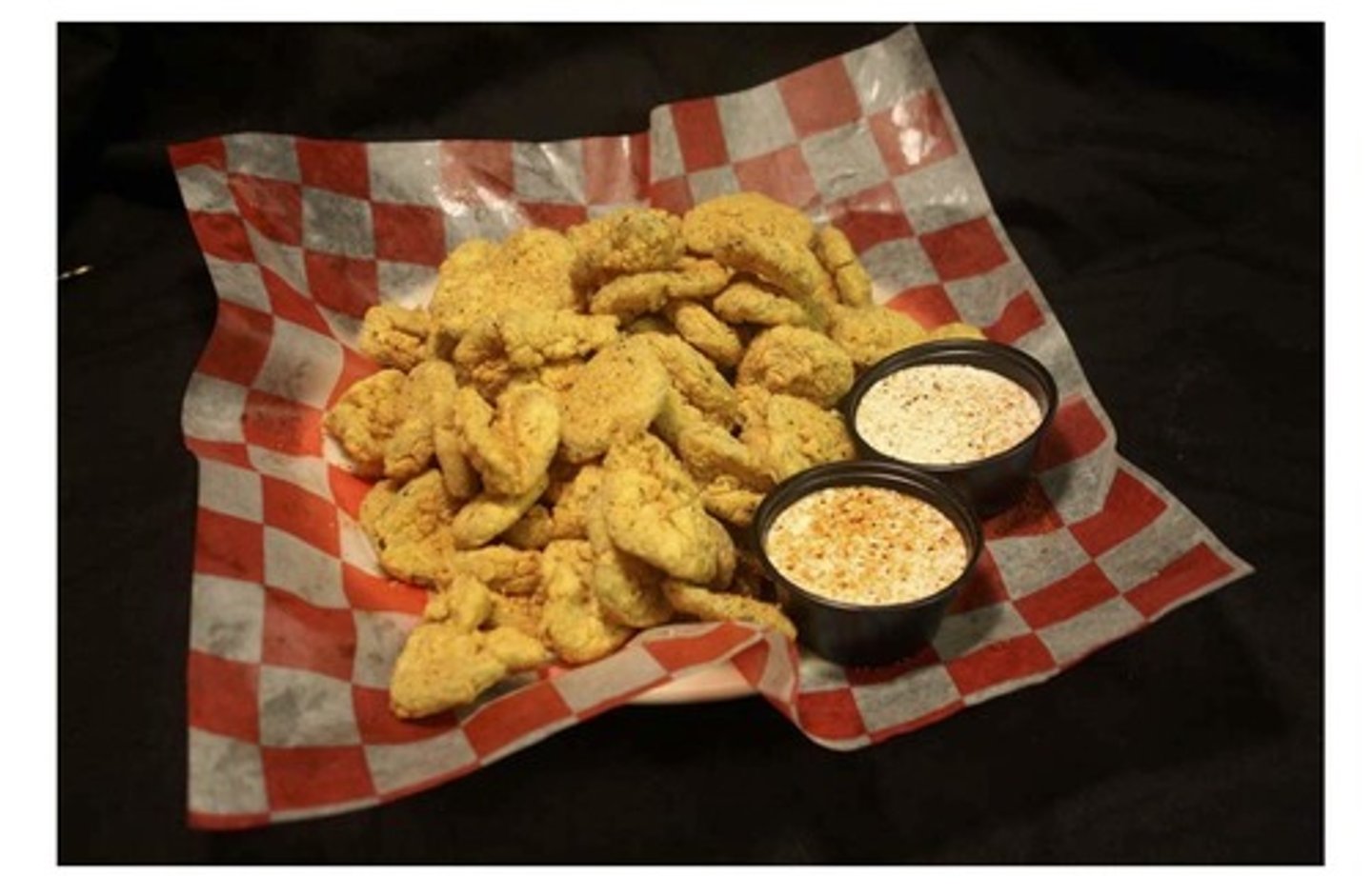 <p>7 oz of pickle wafers hand battered and fried golden brown.</p><p>ranch or cactus blossom sauce</p><p>deli-lined basker</p>