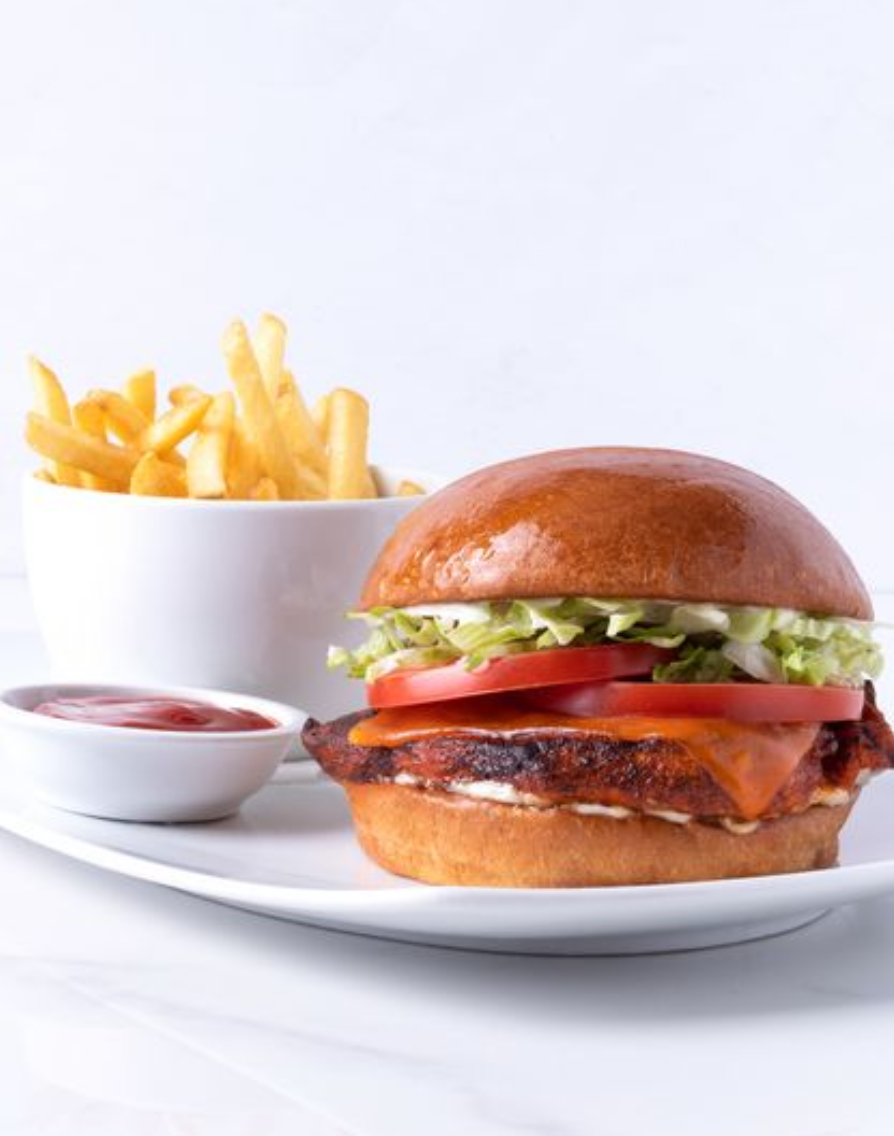 <p><span>blackened cajun chicken, aged cheddar, lettuce, tomato, mayonnaise, brioche bun, sea salted fries</span></p><p><span>➔ Cajun Chicken Breast ➔ Cheddar Cheese<br>➔ Tomato<br>➔ Sea salted fries ➔ Brioche bun (or gluten free bun available) ➔ Shredded lettuce ➔ Mayonnaise</span></p>