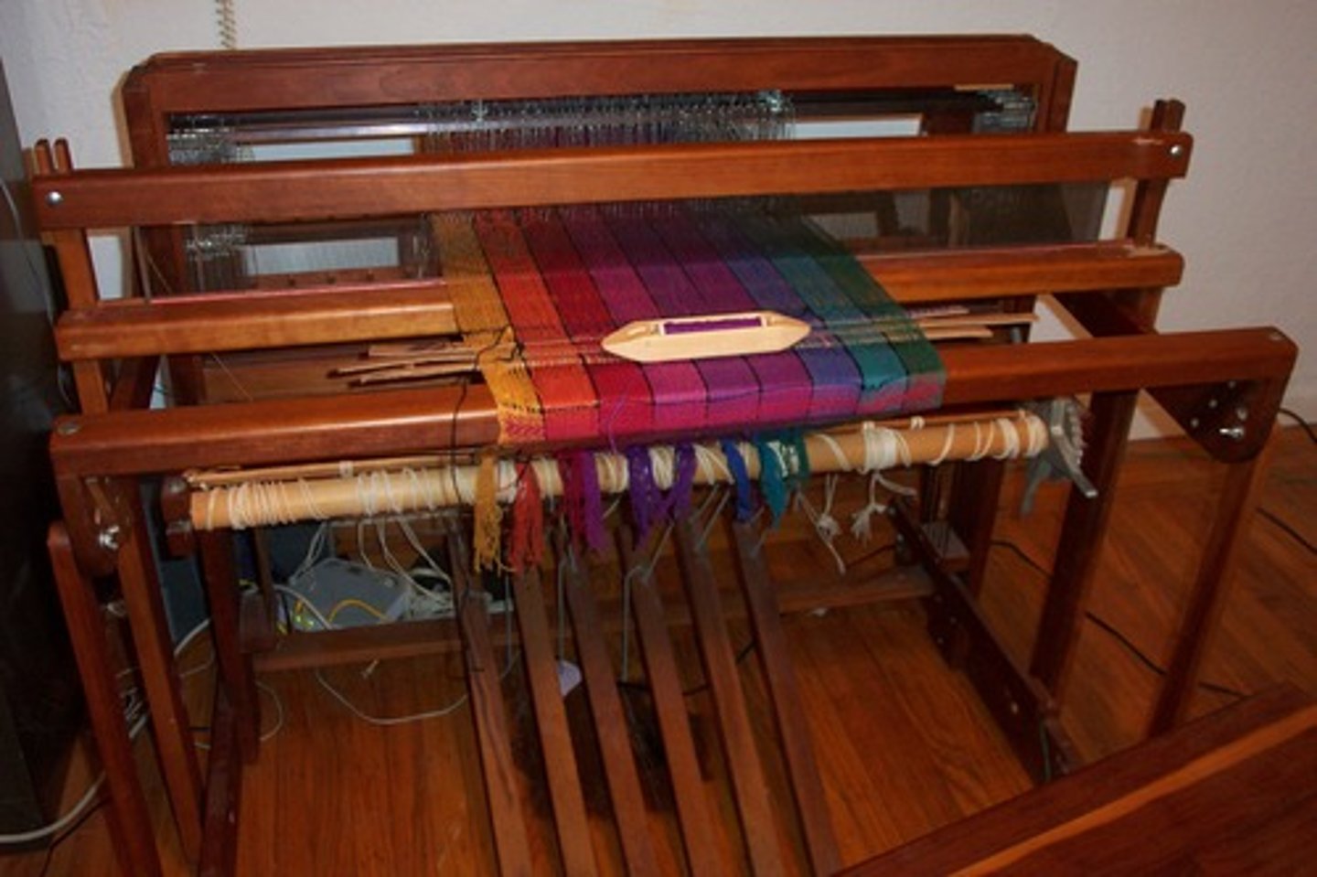 <p>A machine used in the industrial revolution that sped up the process of weaving on a loom, doubling the output of material. However, it would lead to shortages in yarn because of how much faster it worked.</p>