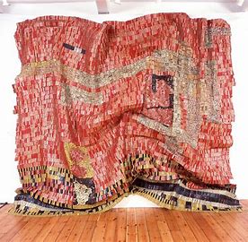 <p>When: 2004 (21st Century) Who: El Anatsui Extra Facts: made of aluminum bottle caps, Kente Cloth</p>