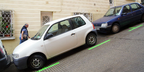 <p><strong>Shift the gear to&nbsp;‘reverse’ and pull up the handbrake with the steering wheel turned to the left(Two front wheels facing inwardly and towards the roadside).</strong></p>