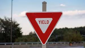 <p>How does the yield sign look and mean</p>