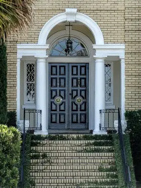 <p>a door with a semicircular window above it and flanked by vertical windows</p>