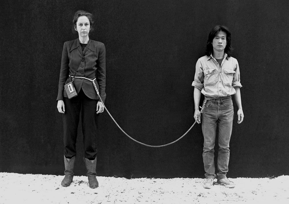 <p>Title: Art/Life One Year Performance</p><p>Time: 1980s.</p><p>Known for:</p><ul><li><p class=""><em>A</em> durational performance in which they spent <strong>one full year tied together by an 8-foot rope</strong>, without ever touching each other, and without spending a moment apart unless in emergencies.</p></li><li><p class="">It explores <strong>endurance</strong>,<strong> interpersonal boundaries</strong>, and <strong>the tension between connection and autonomy</strong>, questioning the limits of time, intimacy, and commitment as both artistic material and lived experience.</p></li></ul><p></p>