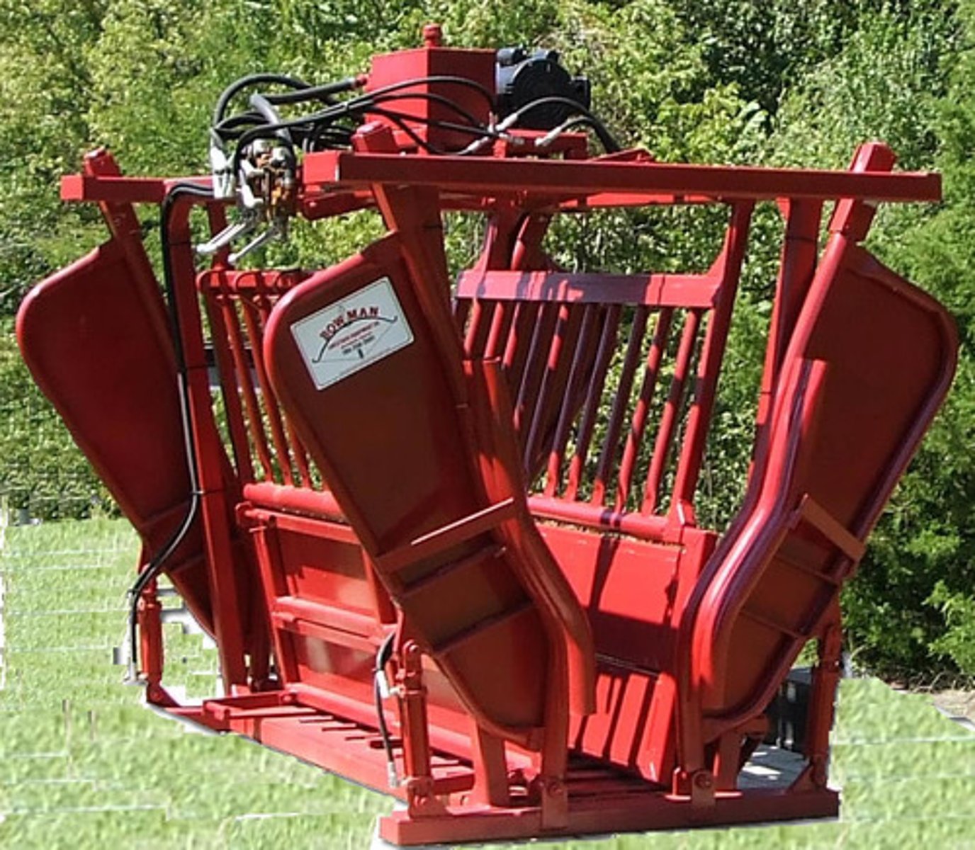 <p>a strongly built stall or cage for holding cattle, horses, or other livestock safely while they are examined, marked, or given veterinary treatment.</p>