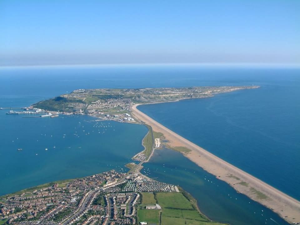 <p>Chesil Beach joining to Portland is an example of a tombola.</p>