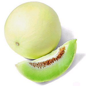 features a white-yellow-brown skin that ranges from a bumpy texture (when more unripe) to a smoother texture (ripe). The fruit itself is light green in color with a lighter middle. There are brown seeds. The fruit is round in shape.