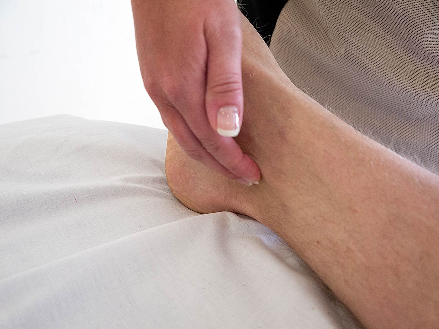 <ul><li><p>behind ankle bone</p></li></ul><p></p>