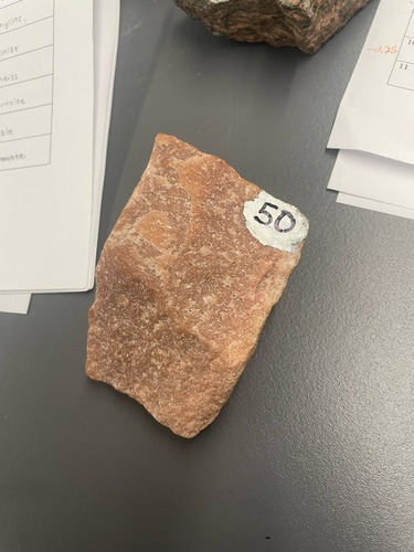 <ul><li><p>Tan/orange</p></li><li><p>Medium sized crystal grains</p></li></ul>