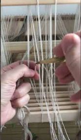 <p>Attaching warp ends to the shafts through heddles &gt; way the warp is threaded determines a set of possible patterns</p>