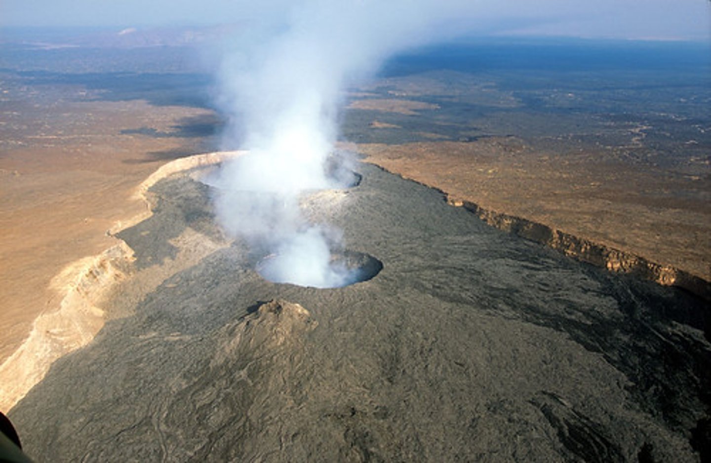 <p>Magma chamber<br>Main vent<br>Crater<br>Ash and cinder cloud <br>Lava flow<br>Secondary vent<br>Layers of lava</p>