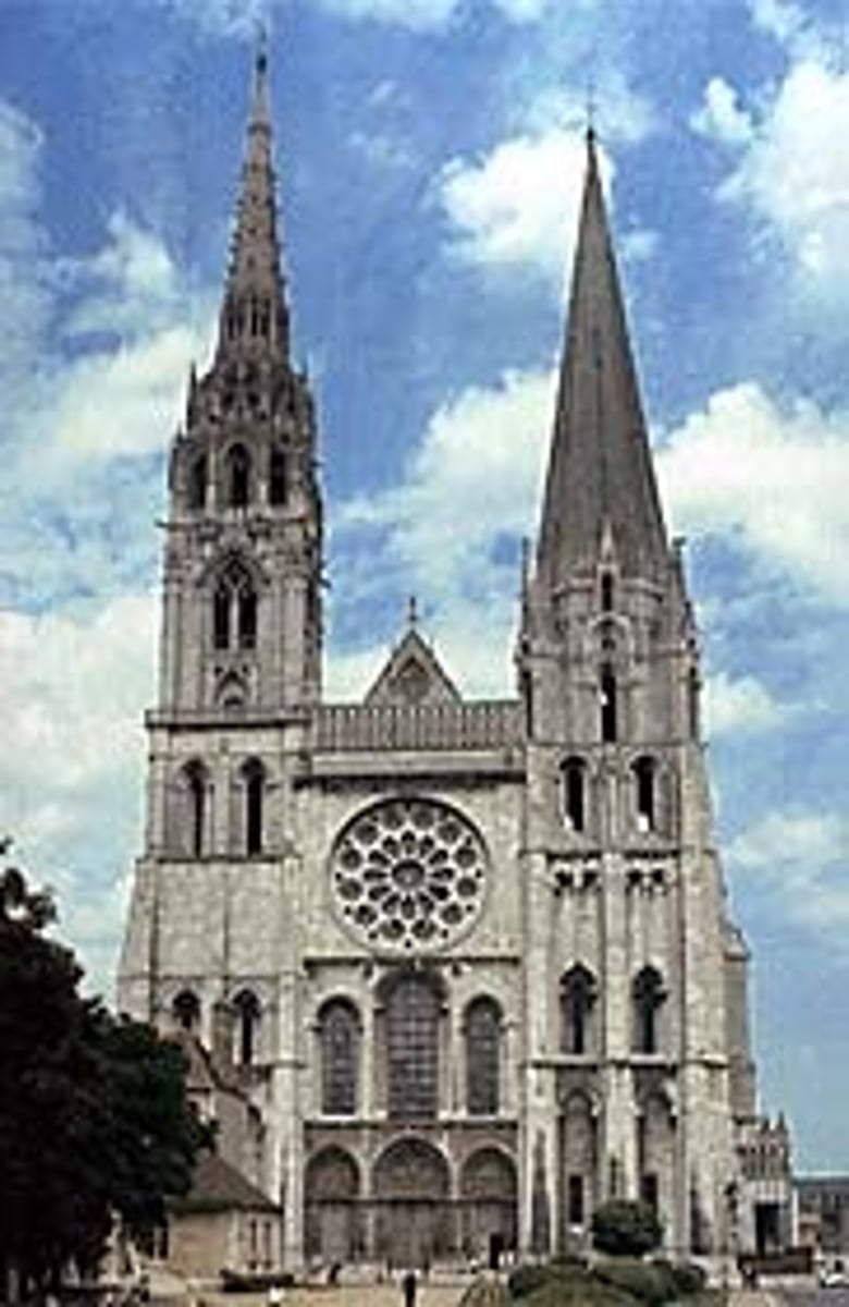 <p>a tapering conical or pyramidal structure on the top of a building, typically a church tower.</p>