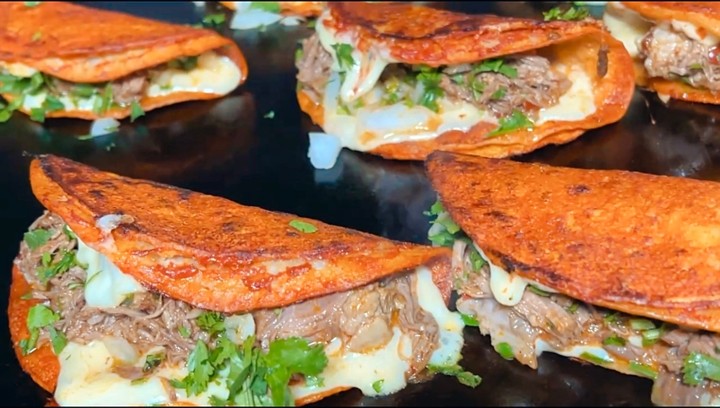 <p>Three red tortillas topped with melted chihuhua cheese filled with choice of meat, cilantro y cebolla, consome cup, rice and beans</p>