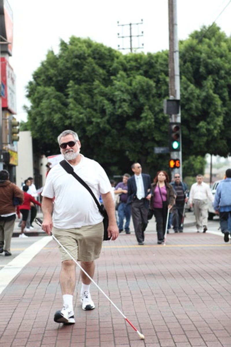 <p>If a pedestrian with a white cane is crossing the street, you should...</p>