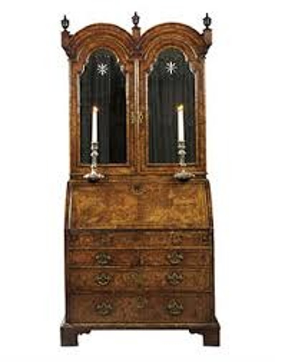 <p>A desk topped with a tall cupboard containing glazed or paneled doors.</p>